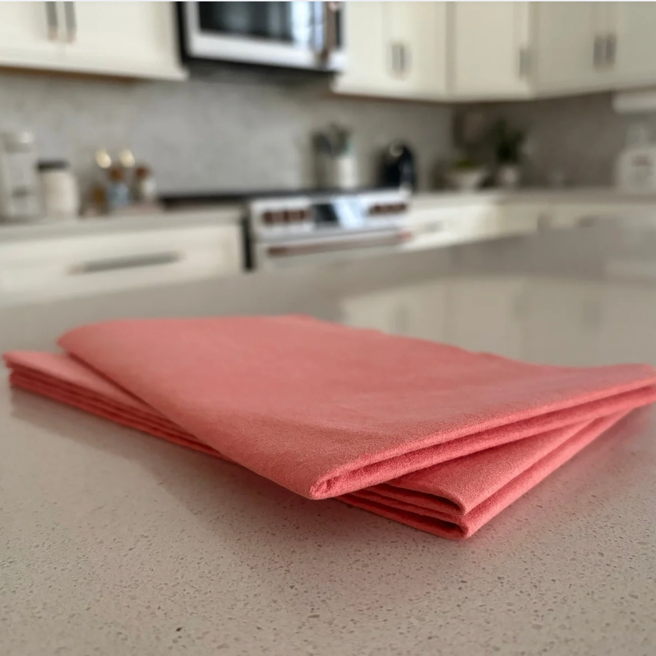 Pink cloth on a kitchen counter with blurred background