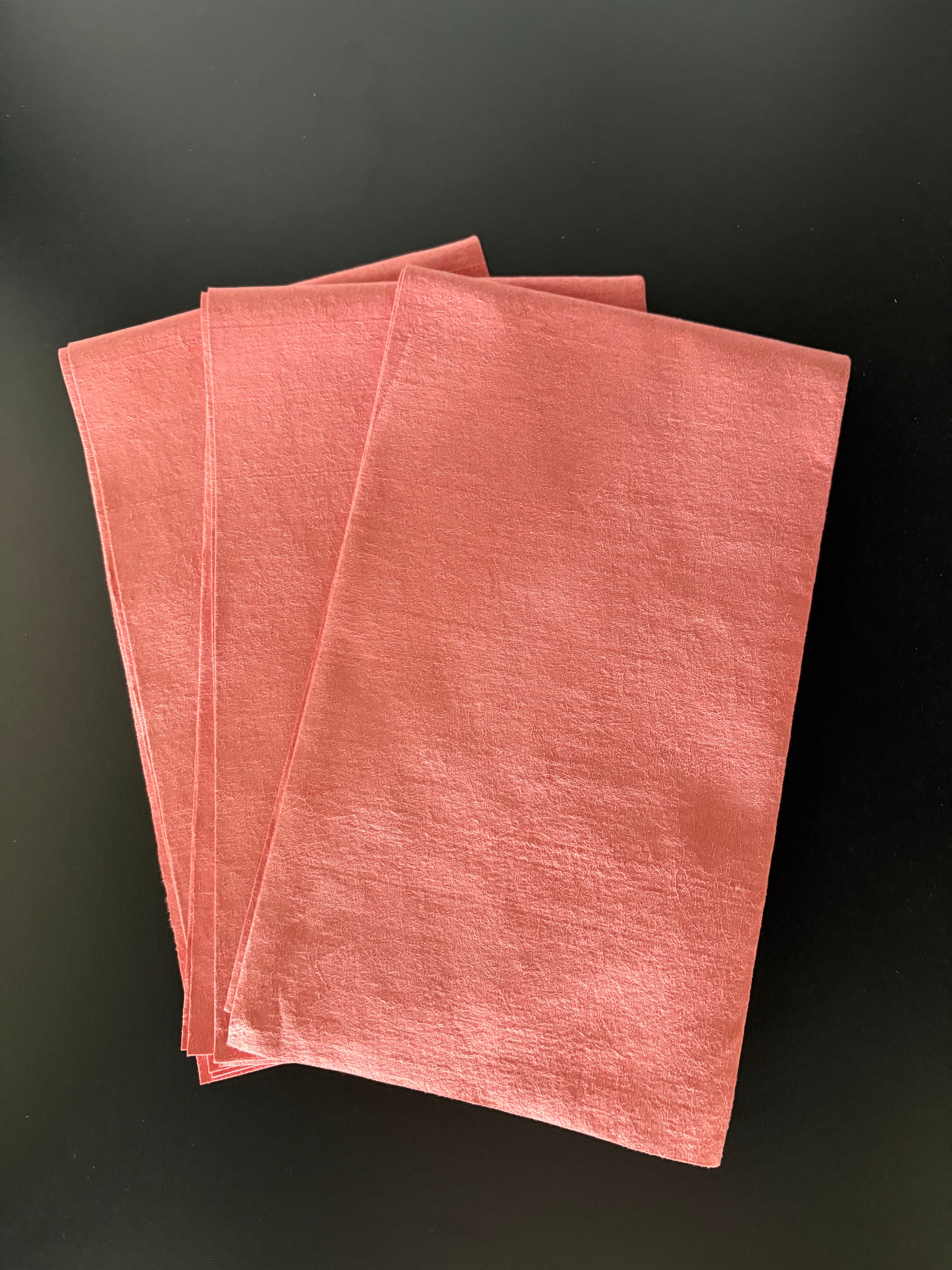 Stack of pink napkins on a black background
