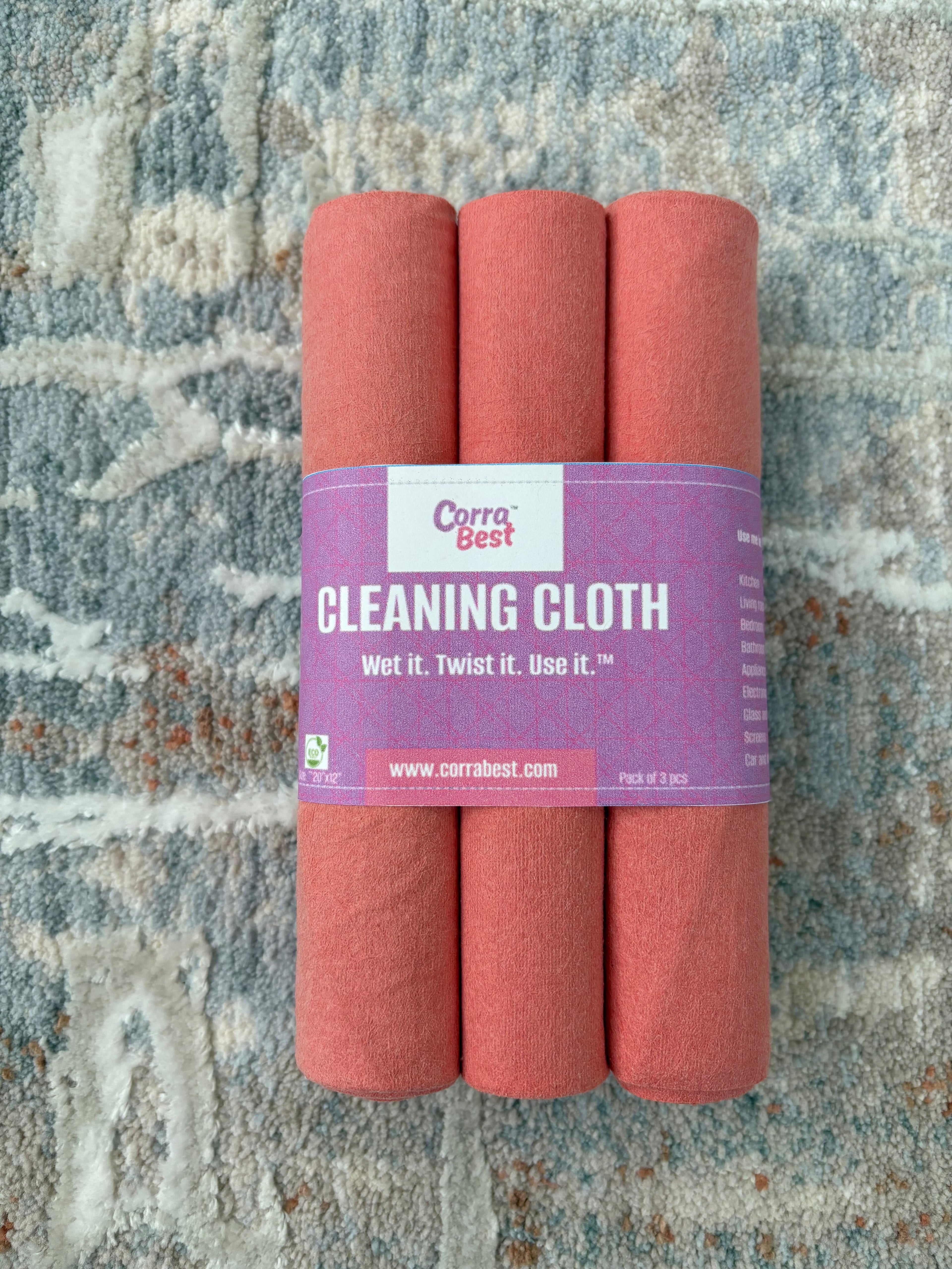 3 corra cloths folded and rolled and packed together with a purple band with product details.
