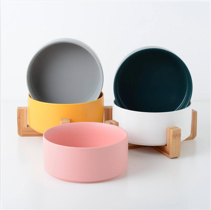 Set of colorful bowls with wooden stands on a white background