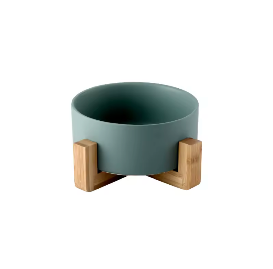 Green pet bowl with wooden stand on a white background