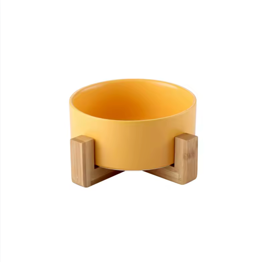 Yellow bowl with wooden stand on a white background