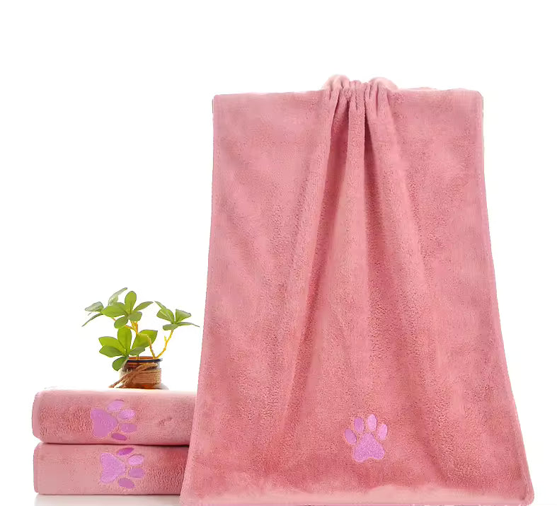 Pink towel with paw prints on a white background